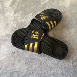 Adidas Black Slides with Gold Stripes